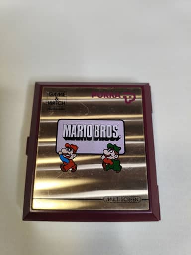 Game & Watch Mario Bros à deux écrans, ouverte, avec le marquage de la marque Pokka, photographiée par le vendeur.
